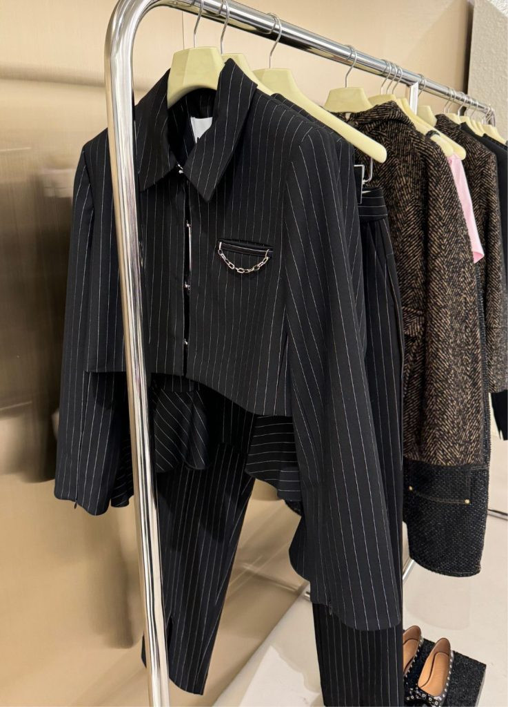 Clothing rack with styled outfits