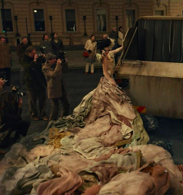 Emma Stone as Cruella De Vil in Disney’s Cruella wearing the Garbage Truck Dress, a rebellious and fashionable statement.
