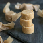 Stacked old fashioned peanut butter candy wrapped in wax paper