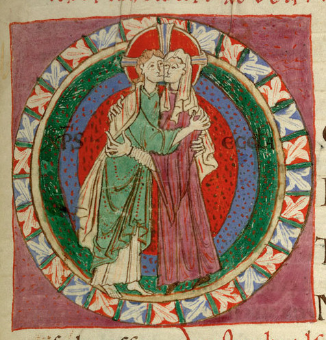 Couple embraising. They both wear long tunics, hers with wider sleeves than his. They both wear a long shirt/cote under it. Hers has long sleeves, while his doesn’t. 1097