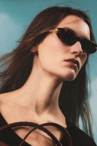 Individual with fashionable sunglasses and a collared shirt