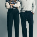 alt text: Men's tailored navy overcoat paired with a gray turtleneck and dark trousers, exuding classic winter elegance
