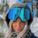 Man wearing ski goggles with a reflective lens.