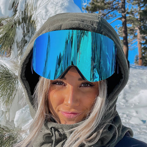 Man wearing ski goggles with a reflective lens.