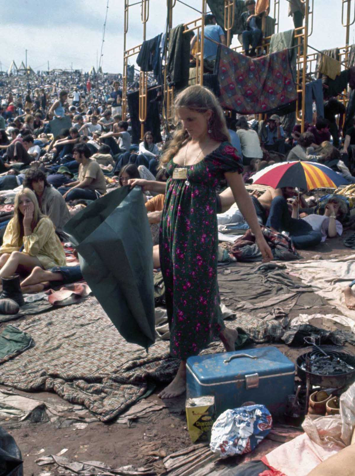 Man in tie-dye shirt with guitar at Woodstock